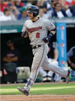  ?? Associated Press ?? Minnesota Twins' Brian Dozier runs the bases after hitting a solo home run off Cleveland Indians relief pitcher Cody Allen in the eighth inning of a baseball game Saturday in Cleveland.