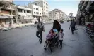  ?? Photograph: Dawoud Abo Alkas/ Anadolu/Getty Images ?? A family leaving the Jabaliya refugee camp walks down Al Celaa Street in Gaza City after an Israeli airstrike on the camp, 12 May 2024.