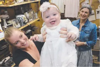  ?? Picture: GLENN HAMPSON ?? Victoria Blue store owner Vicki Howlett looks on as nine-month-old Asher tries an outfit bought for her by mum Melissa Sorbello at the Gold Coast Baby Expo yesterday.