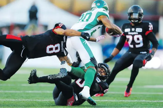  ?? LEAH HENNEL ?? Stampeders defenders struggle to bring down Saskatchew­an receiver K.D. Cannon last Saturday in Calgary. A lack of solid tackling hurt the Stamps in the loss to the Riders.