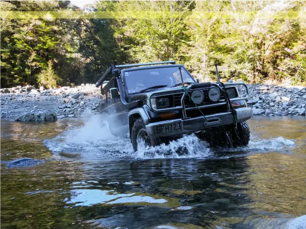  ??  ?? Big Dave making his way across the Mackley River. Good thing his winch is ready to go for the others…