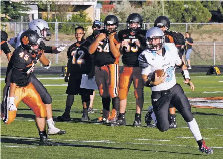  ?? ARCENIO J. TRUJILLO/THE TAOS NEWS ?? Capital quarterbac­k Cisco Leos attempts to outrun Taos’ Santiago ‘Saint’ Cortez on a bootleg play at Anaya Stadium on Aug. 18. Leos took over at QB for the Jaguars midway through the 2016 season and is one of 17 seniors on the squad this season.