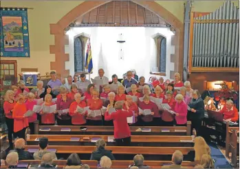  ??  ?? Diana Hamilton leads the Arran Singers in Comes the Light, a poem by Roger McGough which she set to music.