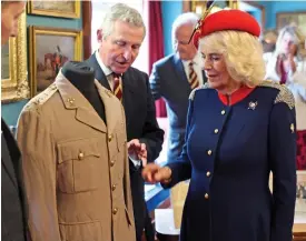  ?? ?? Museum piece: Camilla examines her father’s jacket yesterday