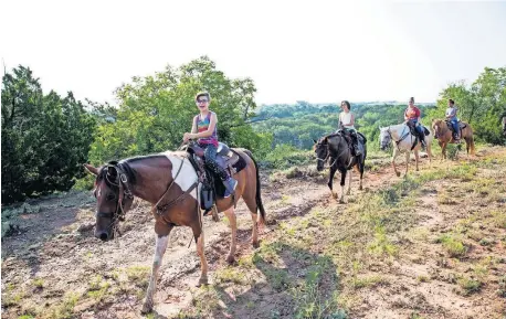  ?? [LORI DUCKWORTH/OKLAHOMA TOURISM] ?? At Roman Nose State Park, experience the gypsum rock cliffs and natural springs on horseback.