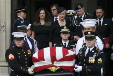  ?? SUSAN WALSH — THE ASSOCIATED PRESS ?? The casket of Sen. John McCain, R-Ariz., is carried out of the Washington National Cathedral in Washington, Saturday after a memorial service, as Cindy McCain is escorted by her son Jimmy McCain and other family members.