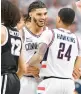  ?? JESSICA HILL/AP ?? Uconn’s Andre Jackson Jr., left, smiles as he celebrates with teammate Jordan Hawkins during Wednesday’s game against Providence in Storrs.