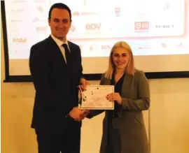  ??  ?? PS Dr Clifton Grima presenting a certificat­e to weightlift­er Yazmin Zammit Stevens