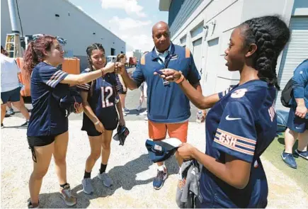  ?? ?? New Bears president and CEO Kevin Warren fist bumps Valenzuela, from left, Rodriguez Martinez and Shotwell during the Bears training camp.