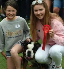  ??  ?? Holly and Sinead Barrett (Beaufort) with their dog Bruno at the dog show. Photo by Don MacMonagle.