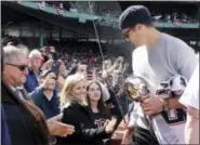  ?? ELISE AMENDOLA — THE ASSOCIATED PRESS ?? New England Patriots quarterbac­k Tom Brady greets fans as he leaves the field after throwing the ceremonial first pitch during Boston Red Sox Home Opening Day ceremonies at Fenway Park, Monday in Boston. The Red Sox face the Pittsburgh Pirates in the...