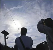  ?? ?? People in Minamitane town, Kagoshima, southern Japan, watch as an H3 rocket lifts off from Tanegashim­a Space Center on Saturday.