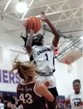  ?? RICHARD BURKHART/SAVANNAH MORNING NEWS ?? Calvary's Destini Gooddine goes up for a basket over Dawson County's Anna Ayers during the State quarterfin­als on Tuesday February 28, 2023.