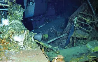  ??  ?? Hulk: Wreckage of the Indianapol­is found 18,000ft down in the Philippine Sea Sea floor: Debris from a spare parts box