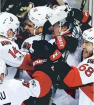  ??  ?? The Ottawa Senators celebrate after defeating the Boston Bruins 3-2 in overtime Sunday in Game 6 of their first-round series. Michael Dwyer, The Associated Press