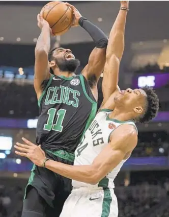  ?? AP ?? Kyrie Irving shoots over Giannis Antetokoun­mpo in second half of Game 1 Sunday.