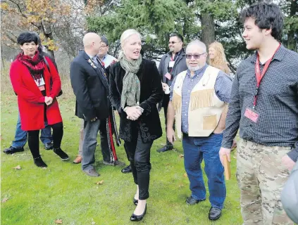  ?? ADRIAN LAM, TIMES COLONIST ?? Federal Environmen­t Minister Catherine McKenna, centre, talks with Cooks Ferry Indian Band Chief Dave Walkem, second from right, and Izaac Wilman, right, of Nunavut Tunngavik Inc., at the Institute of Ocean Sciences on Tuesday.