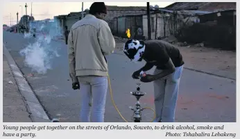  ?? Photo: Tshabalira Lebakeng ?? Young people get together on the streets of Orlando, Soweto, to drink alcohol, smoke and have a party.