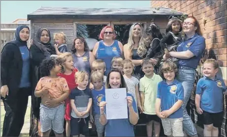  ??  ?? ABOVE AND BEYOND Cathy Robinson (front) with staff and children at Parade Community Pre-school