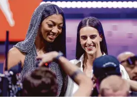  ?? Adam Hunger/Associated Press ?? LSU’s Angel Reese, left, and Iowa’s Caitlin Clark pose for a photo before the WNBA draft on Monday in New York.