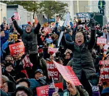  ?? REUTERS ?? People gathered outside the National Assembly in Seoul celebrate after the vote to impeach President Park Geun-hye.