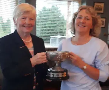  ??  ?? Bridget Murphy receiving the New Ross Centenary Cup prize from Liz Roberts (President).