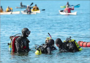  ?? DANA JENSEN/THE DAY ?? Instructor­s from New England Dive in Wallingfor­d work with students Saturday on open-water scuba diving off shore from duBois Beach in Stonington. The open-water lesson is the last step before students become certified divers.
