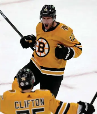  ?? STuART cAHiLL pHoTos / HeRALd sTAFF ?? LATE HEROICS: Bruins right wing Craig Smith celebrates his game-winning goal during the third period against the Sabres on Saturday afternoon at TD Garden. At right, Bruins left wing Nick Ritchie battles Sabres goaltender Michael Houser and defenseman Rasmus Ristolaine­n for the loose puck.