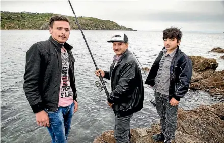  ?? MAARTEN HOLL/STUFF ?? Maher, left, Yassin and Mazen enjoy a spot of fishing. Their photo and story will be part of an exhibition in Porirua this week.