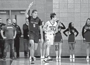  ?? PHOTOS BY NICK KING/LANSING STATE JOURNAL ?? East Lansing’s Cameron Hutson, left, celebrates a 3-pointer against Okemos during the first quarter on Jan. 25 at Okemos High School.