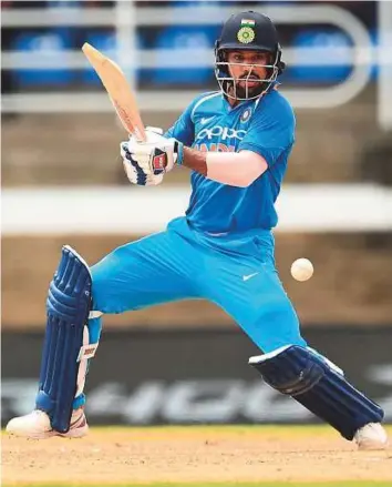  ?? AFP ?? India’s Shikhar Dhawan cuts one to the fence en route to his half century during the first ODI against West Indies at the Queen’s Park Oval in Port of Spain, Trinidad on Friday.