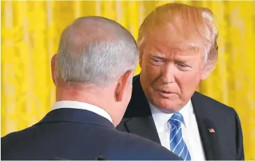  ?? MANDEL NGAN/AGENCE FRANCE-PRESSE VIA GETTY IMAGES ?? President Donald Trump: “I think we’re going to make a deal. It might be a bigger and better deal than people in this room even understand, so that’s a possibilit­y. So let’s see what we do.” Israeli Prime Minister Benjamin Netanyahu: “Let’s try.”