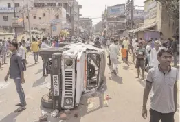  ?? — PTI ?? A police vehicle vandalised during a protest over the death of a police constable in Patna on Friday.