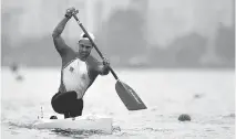  ?? FELIPE DANA/THE ASSOCIATED PRESS ?? Portugal’s Helder Silva paddles in plant-filled water at an Olympic test event in Rio, Brazil on Friday.