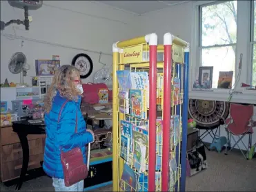  ?? COURTESY ST. MARY’S THRIFT SHOP ?? An early-bird browser checks out children's books for sale at St. Mary's Catholic Church Thrift Shop.