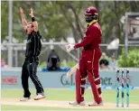  ??  ?? New Zealand bowler Doug Bracewell, left, celebrates the crucial wicket of West Indies dangerman Chris Gayle. Photo: PHOTOSPORT