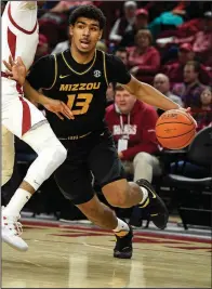  ?? AP/MICHAEL WOODS ?? Missouri guard Mark Smith (13) might miss tonight’s game against Arkansas with an injured ankle. Smith has not played since Jan. 23 when he was hurt with 1:06 left in the Tigers’ 72-60 loss at Arkansas.