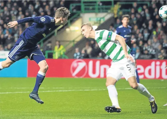  ??  ?? Celtic’s Jozo Simunovic (right) deflects the ball into his own net to hand Anderlecht a 1-0 victory at Parkhead last night.