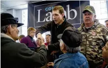  ??  ?? LEFT: Conor Lamb, the Democratic congressio­nal candidate in Pennsylvan­ia’s 18th District, greets supporters after speaking to the United Mine Workers of America on Sunday. GETTY IMAGES RIGHT: Republican Rick Saccone talks with supporters at a campaign...