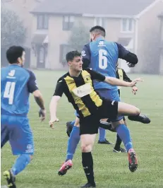  ??  ?? Action from a top-flight game between ICA Sports (blue) and Crowland.