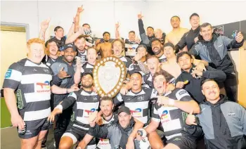  ?? Photo / photosport.co.nz ?? Hawke’s Bay celebratin­g with the Shield in the changing sheds after their victory over Wellington on Saturday.