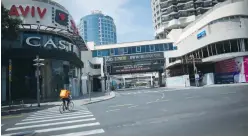  ?? (Miriam Alster/Flash90) ?? A DELIVERY MAN rides on Tel Aviv’s empty Dizengoff Street on Wednesday during the lockdown.