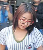  ??  ?? Jidarat Promkhun, another accomplice, is taken to Khon Kaen Provincial Court, where police sought her detention.