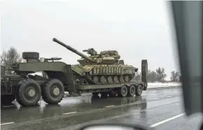  ?? ?? A military truck transports a platform with a Ukrainian tank Tuesday near Kosyantyni­vka, Ukraine.
