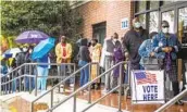  ?? MICHAEL HOLAHAN AP ?? Voters line up to cast their ballots on the first day of early voting in Georgia, Dec. 14. More than 2.5 million ballots have been cast.