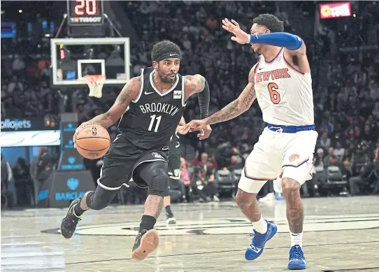  ??  ?? The Knicks’ Elfrid Payton guards the Nets’ Kyrie Irving in the first half of their NBA game at Barclays Center.