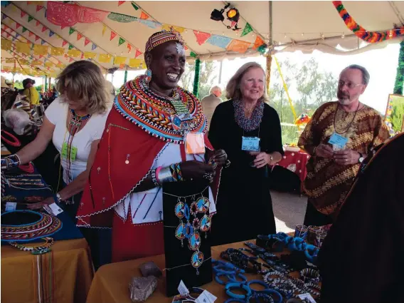  ?? PHOTO BY LISA LAW ?? Rebecca Lolosoli, a bead artist from Kenya, chats with visitors at the Internatio­nal Folk Art Market in Santa Fe.