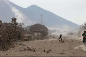  ?? AP/LUIS SOTO ?? The Volcano of Fire continues to spill out smoke and ash Monday as residents evacuate from Escuintla, Guatemala.