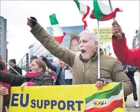  ?? Virginia Mayo Associated Press ?? IN BRUSSELS, supporters wave f lags of the National Council of Resistance of Iran as they demonstrat­e outside European Union headquarte­rs before Thursday’s meeting. Foreign ministers of the EU and Iran have said talks will focus on preserving the 2015...