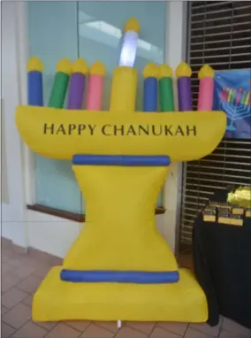  ?? LAUREN HALLIGAN - MEDIANEWS GROUP ?? An inflatable menorah is displayed during a Chanukah Party event on Sunday at Wilton Mall.